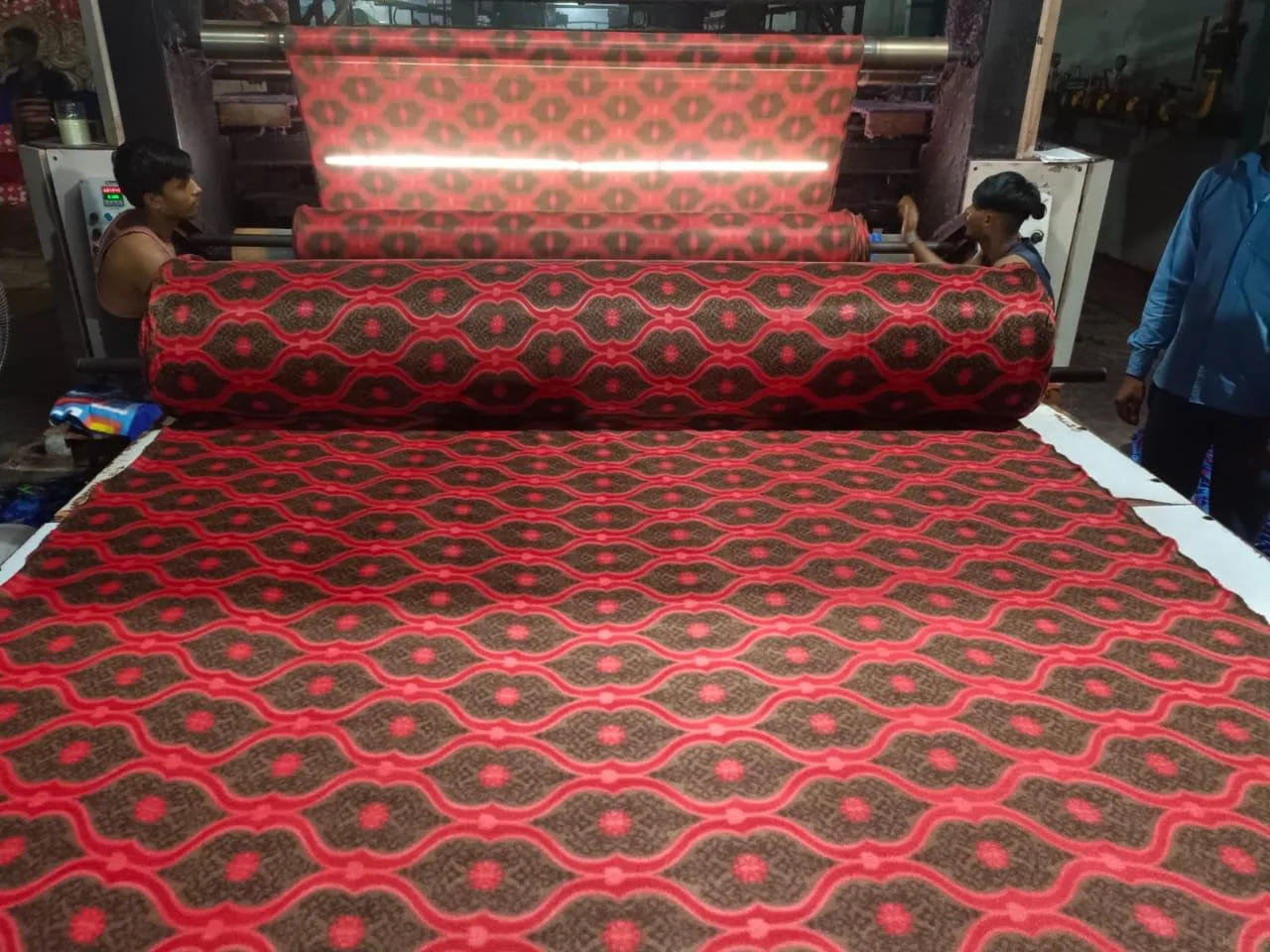 Polar fleece blanket production line running a red ogee print at the Panipat unit