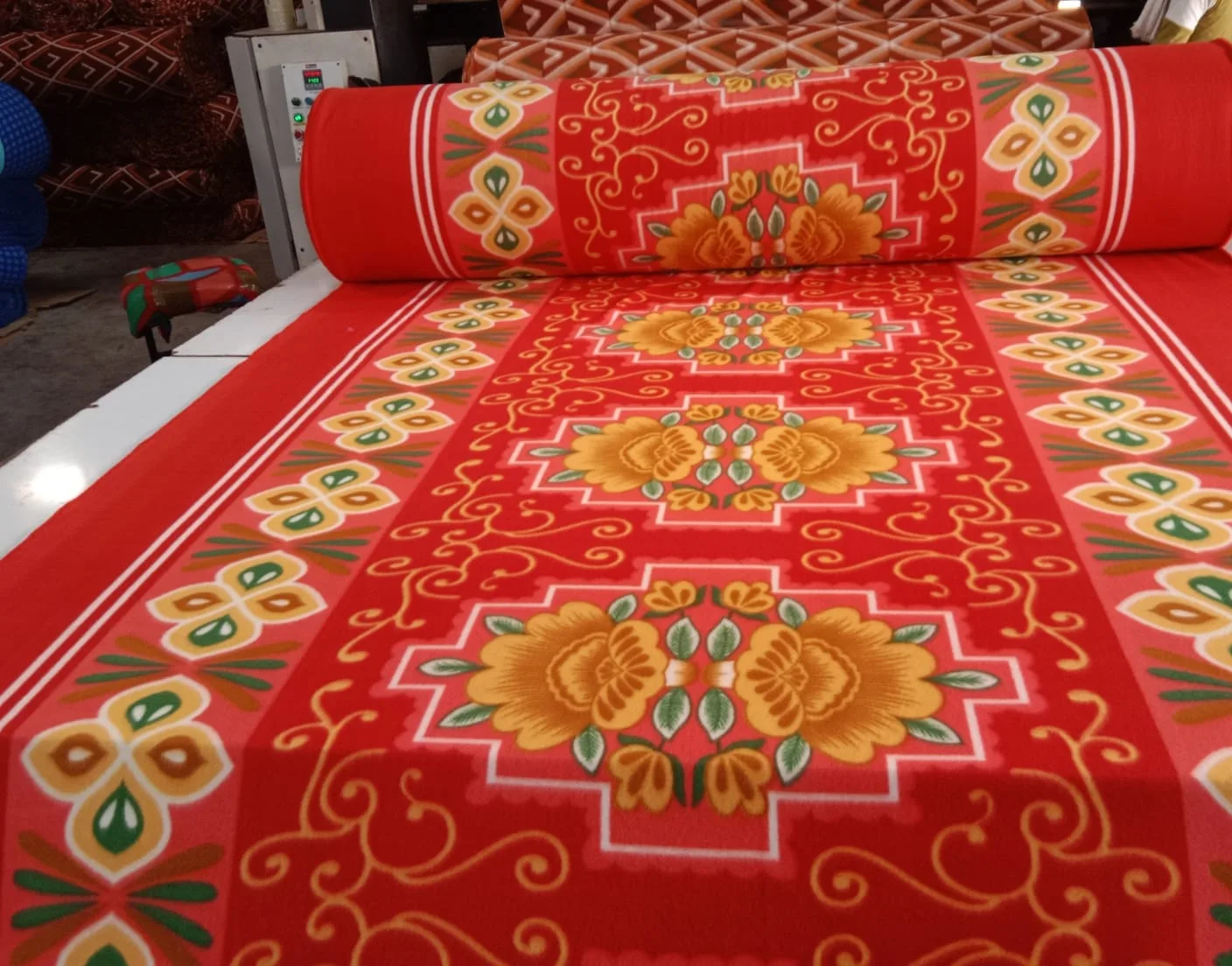 1000 GSM printed polar fleece blanket fabric in a red and gold floral medallion design