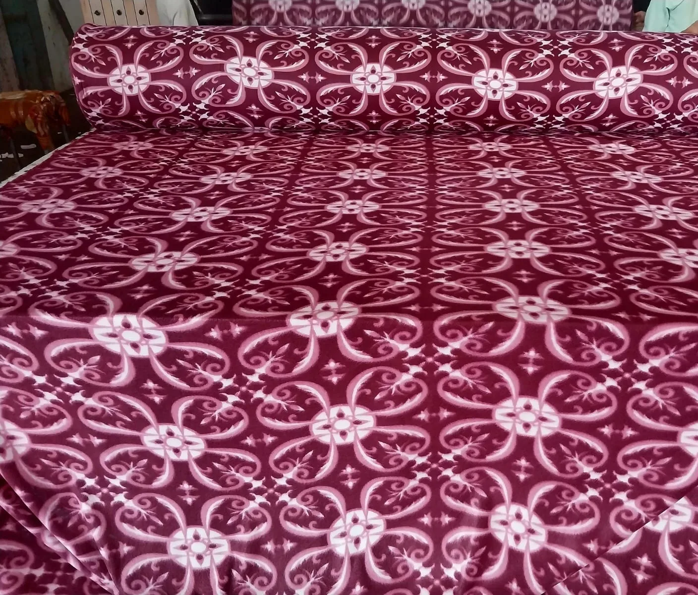 Printed polar fleece blanket fabric in a maroon and white damask floral print