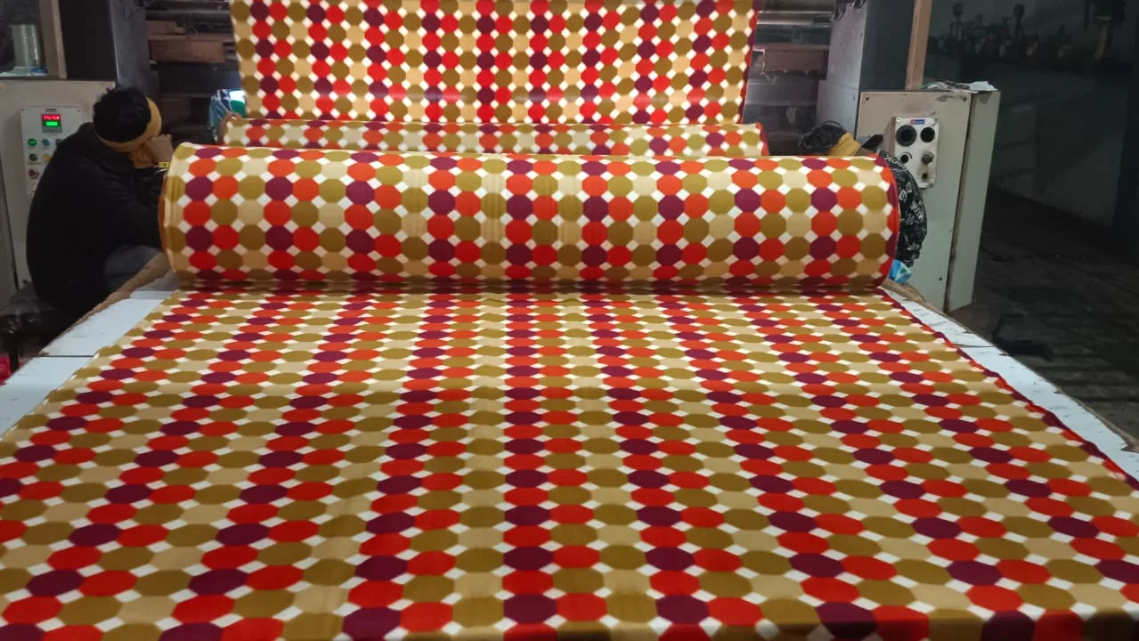 Snow fleece dohar fabric in a red, maroon and olive hexagon dot print